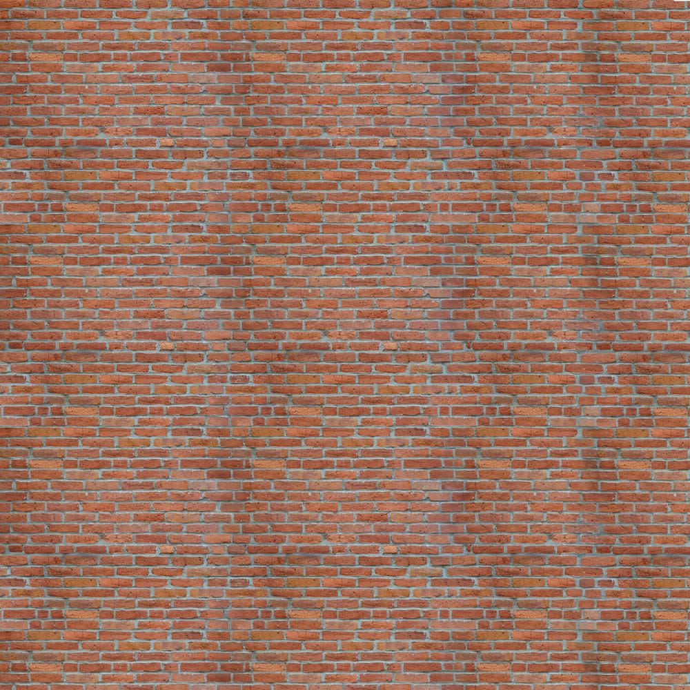 Textur von roten Backsteinen mit sichtbaren Fugen und unregelmäßigen Oberflächen.
